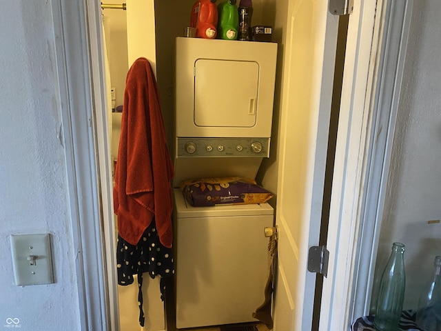 laundry room with stacked washer / drying machine