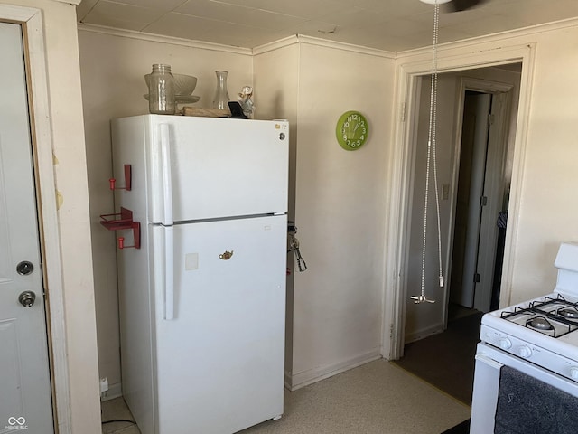 kitchen featuring crown molding and white appliances