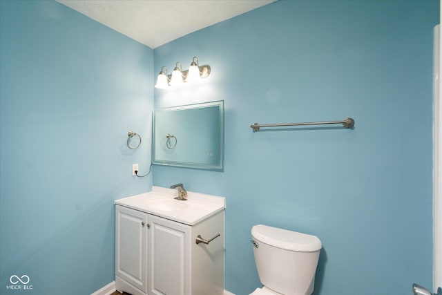 bathroom with toilet and vanity