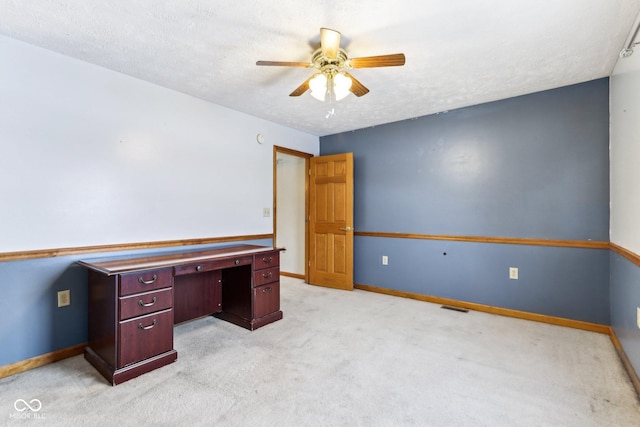 office area featuring light carpet, ceiling fan, a textured ceiling, and baseboards