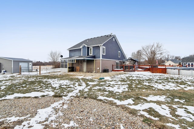 exterior space with a sunroom, fence, a deck, and cooling unit