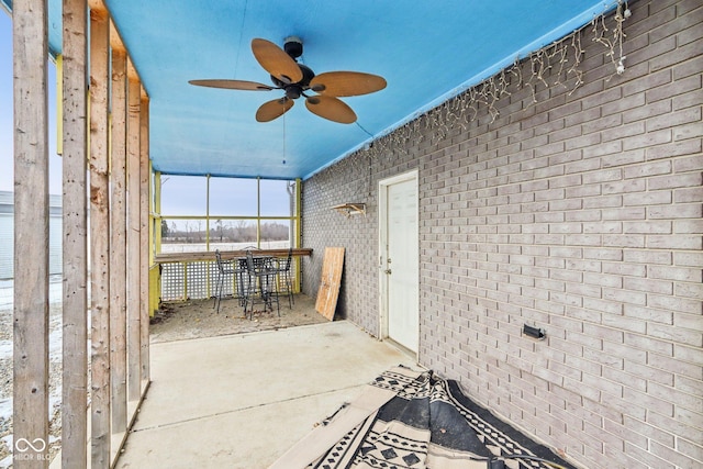 unfurnished sunroom featuring a ceiling fan