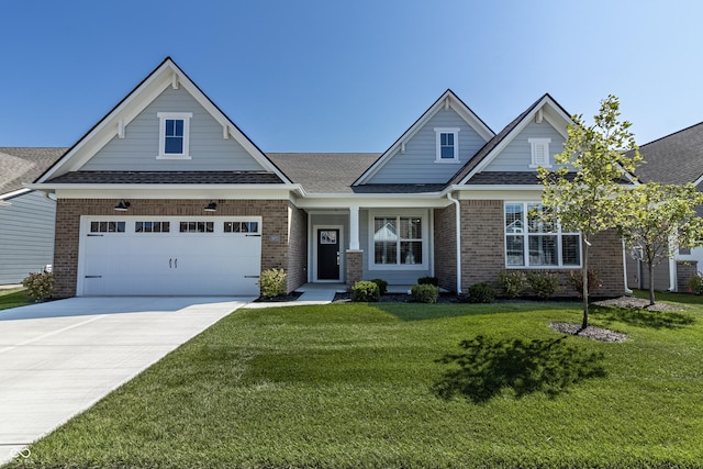 craftsman-style home with a garage and a front lawn