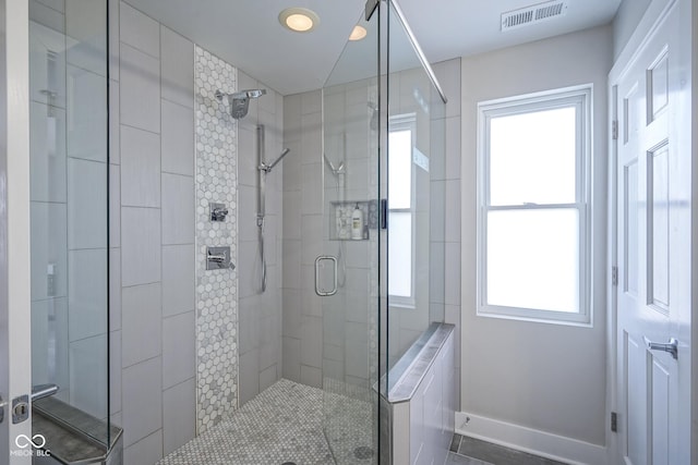 bathroom featuring a shower with shower door