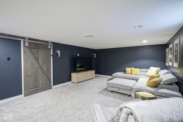 living room featuring a barn door and carpet flooring