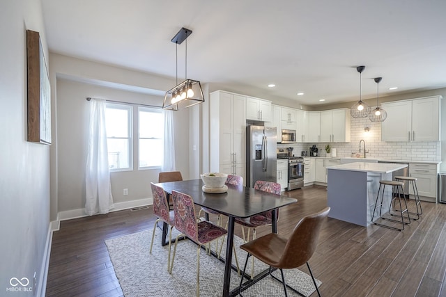 dining room with sink and dark hardwood / wood-style floors