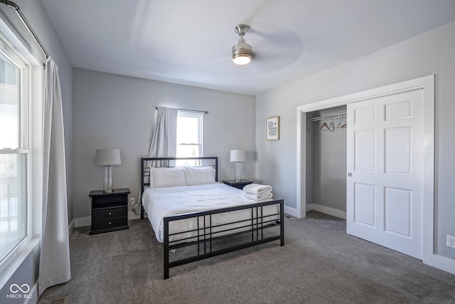 carpeted bedroom featuring ceiling fan and a closet