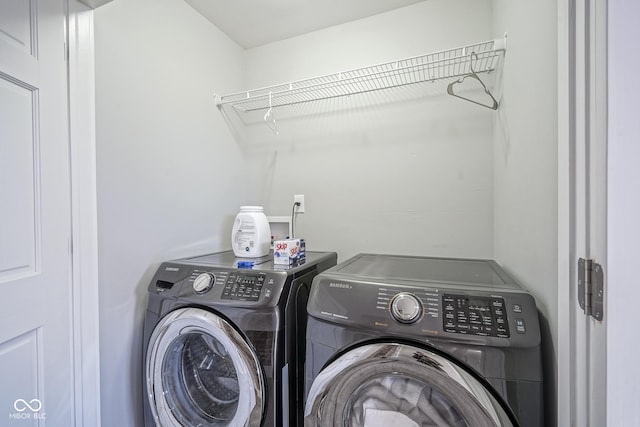 clothes washing area featuring washing machine and clothes dryer