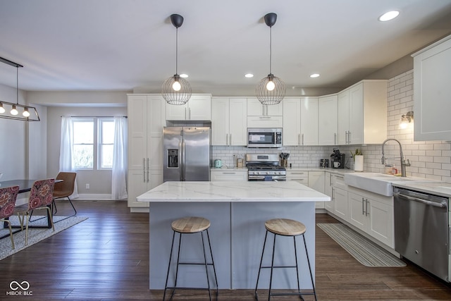 kitchen with appliances with stainless steel finishes, sink, and white cabinets