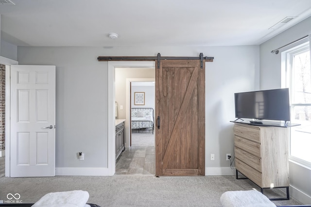 carpeted bedroom with a barn door