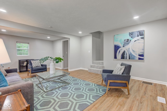 living room featuring hardwood / wood-style flooring and a textured ceiling