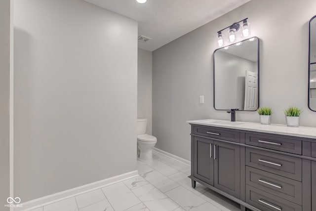 bathroom featuring toilet and vanity