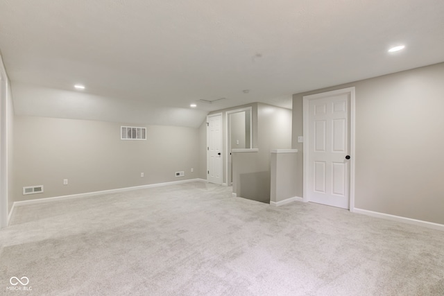 basement featuring light carpet