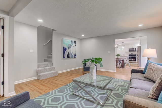 living room featuring hardwood / wood-style flooring and a textured ceiling