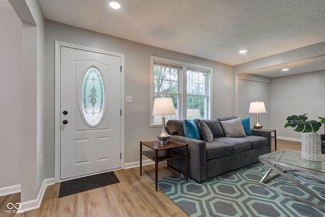 foyer featuring hardwood / wood-style floors and a textured ceiling