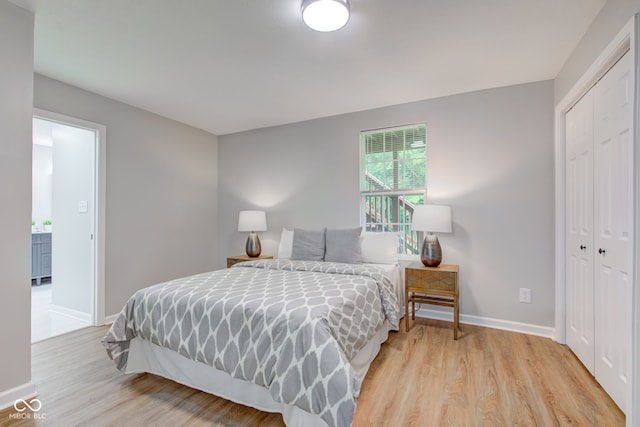 bedroom featuring light hardwood / wood-style floors and a closet