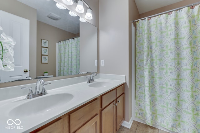 bathroom with tile patterned flooring and vanity