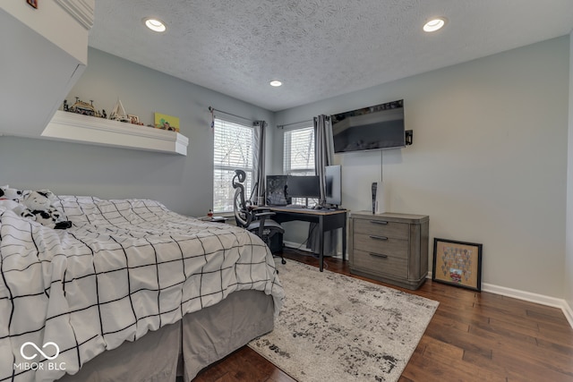 bedroom with dark wood-type flooring and a textured ceiling