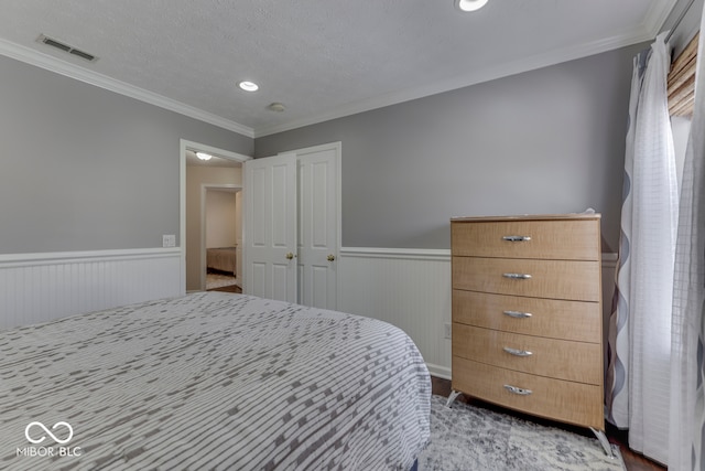 bedroom with crown molding and a textured ceiling