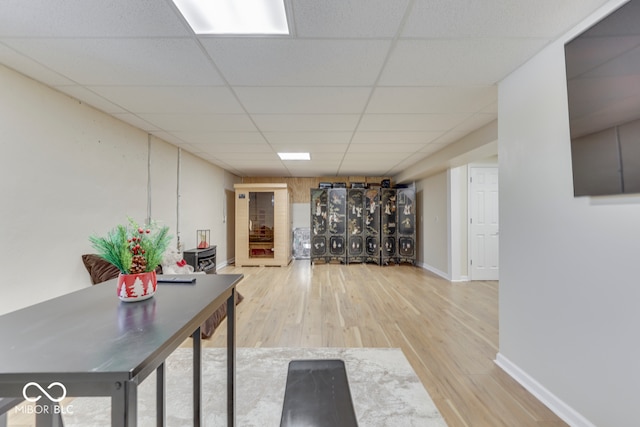 interior space featuring wood-type flooring and a paneled ceiling