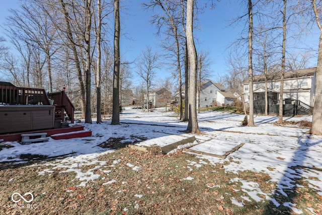 snowy yard featuring a hot tub