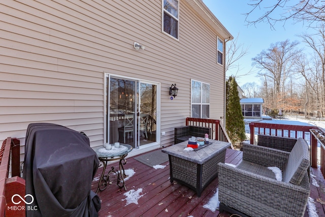 snow covered deck featuring grilling area and outdoor lounge area