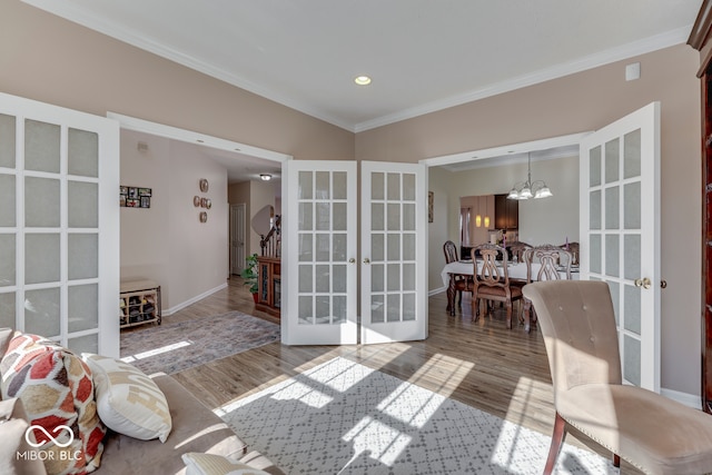 interior space with an inviting chandelier, wood-type flooring, ornamental molding, and french doors