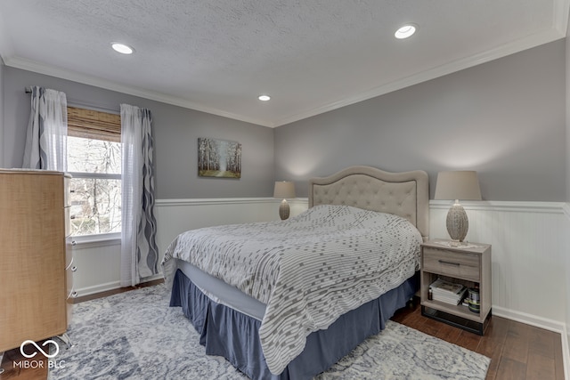 bedroom featuring ornamental molding, dark hardwood / wood-style floors, and a textured ceiling