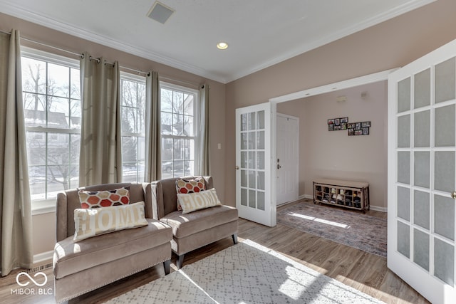 interior space featuring crown molding, light hardwood / wood-style floors, and french doors