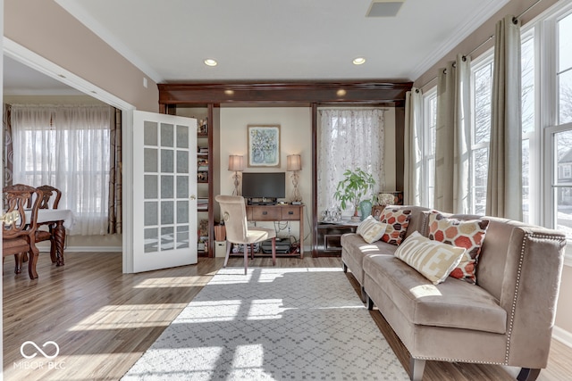 living room featuring ornamental molding and light hardwood / wood-style flooring