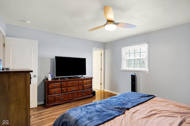 bedroom with ceiling fan and light hardwood / wood-style flooring