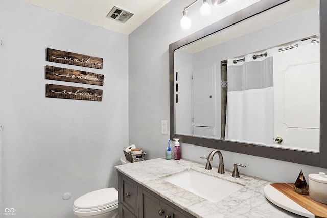 bathroom featuring vanity and toilet