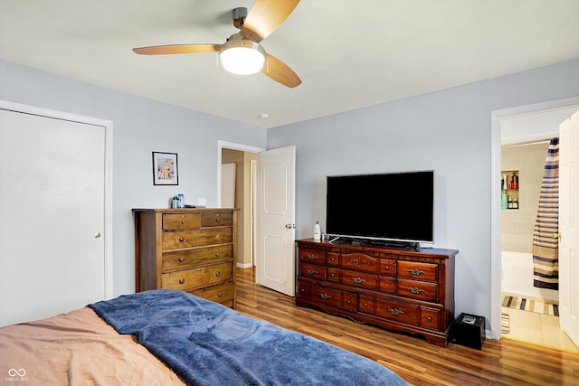 bedroom with ceiling fan, wood-type flooring, and connected bathroom