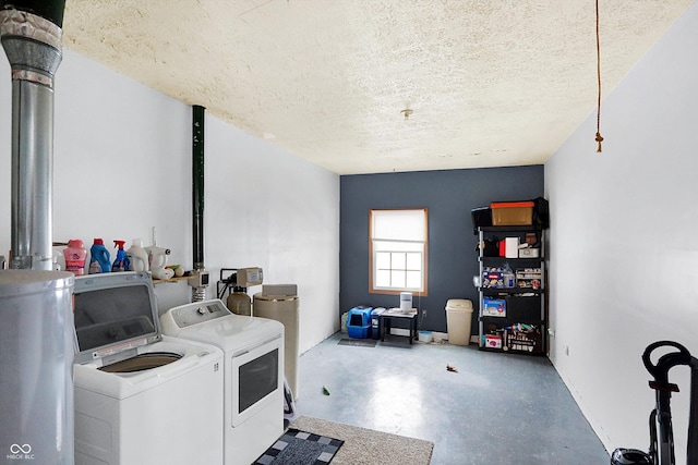 clothes washing area featuring washer and clothes dryer and a textured ceiling