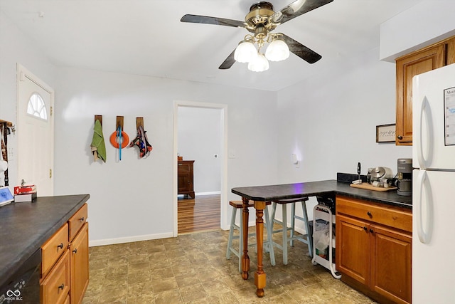 kitchen featuring ceiling fan, dishwasher, and white fridge