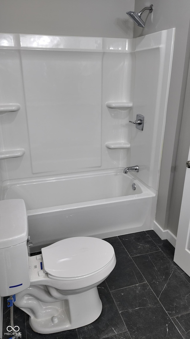 bathroom featuring shower / bathtub combination and toilet