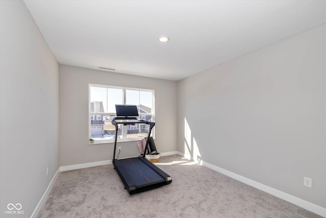 exercise room featuring light colored carpet