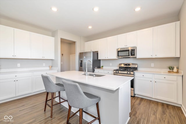 kitchen featuring appliances with stainless steel finishes, sink, and white cabinets