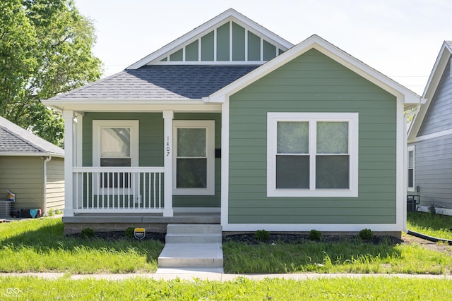 1407 N Pershing Ave, Indianapolis, IN 46222 - bungalow-style home featuring a shingled roof and a porch