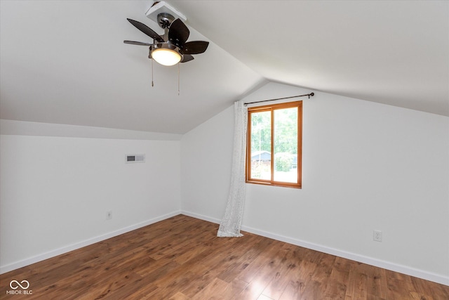 bonus room with lofted ceiling, ceiling fan, wood finished floors, visible vents, and baseboards