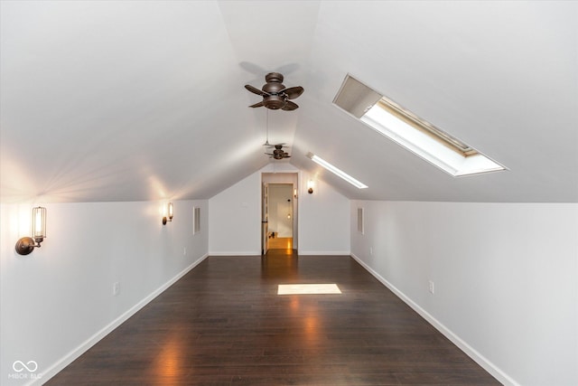 bonus room featuring ceiling fan, dark hardwood / wood-style flooring, and lofted ceiling with skylight