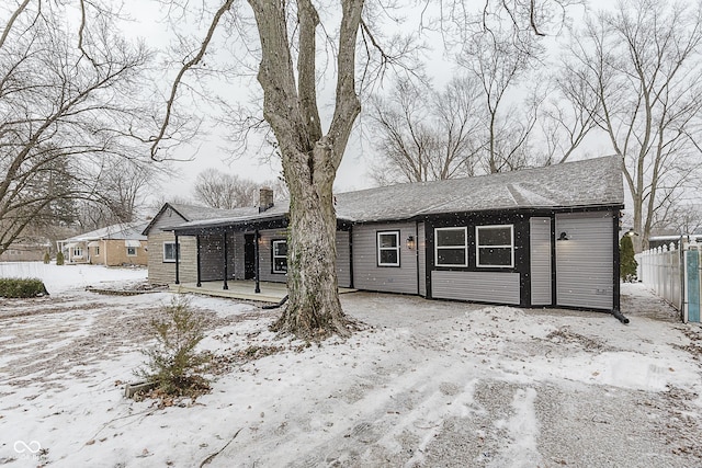 snow covered house with a porch