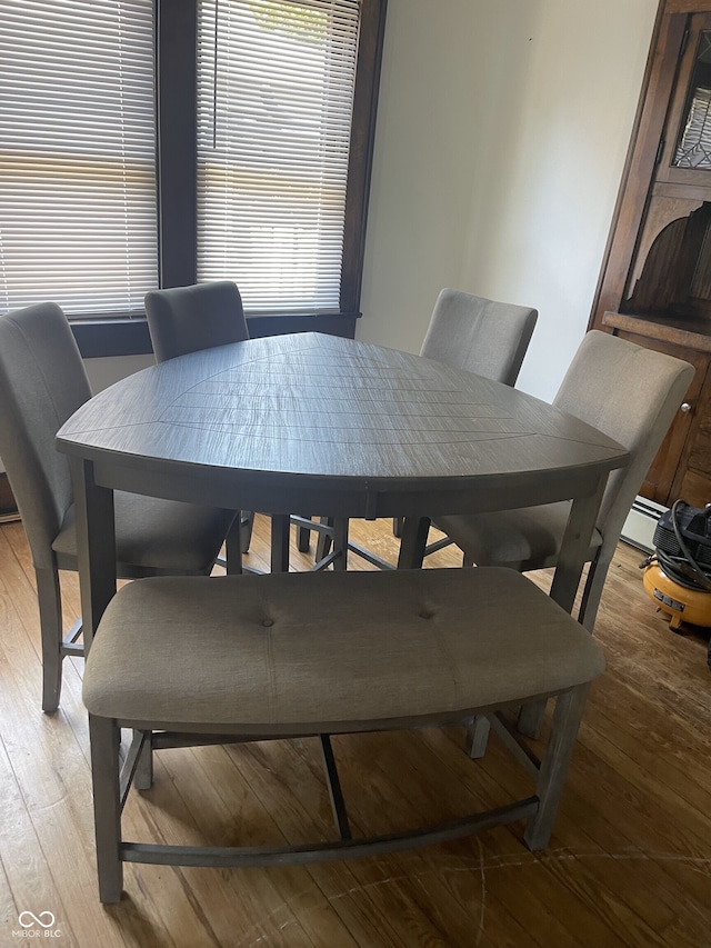 dining room with plenty of natural light and light hardwood / wood-style flooring