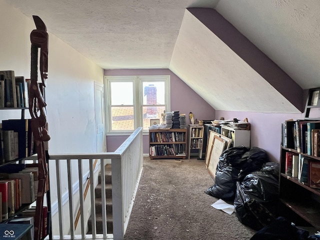 bonus room featuring lofted ceiling, carpet floors, and a textured ceiling