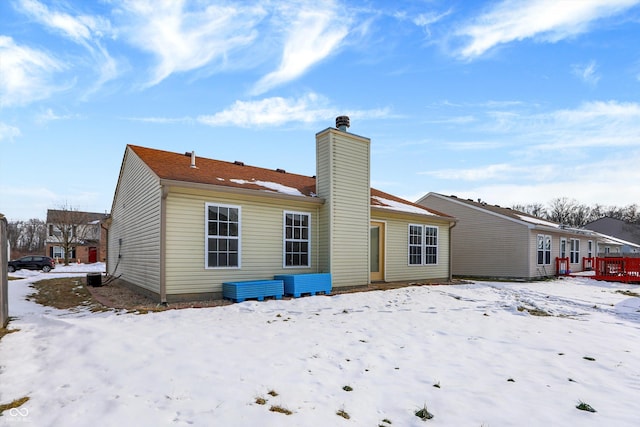 view of snow covered rear of property