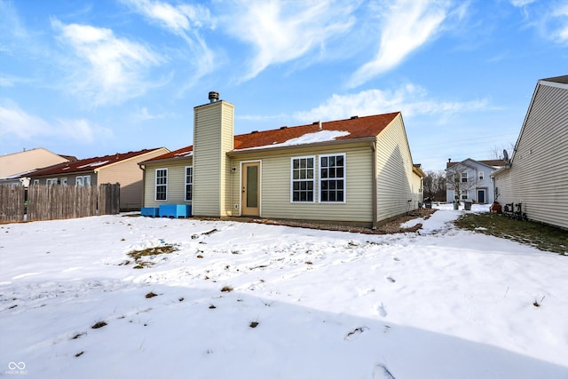 view of snow covered back of property