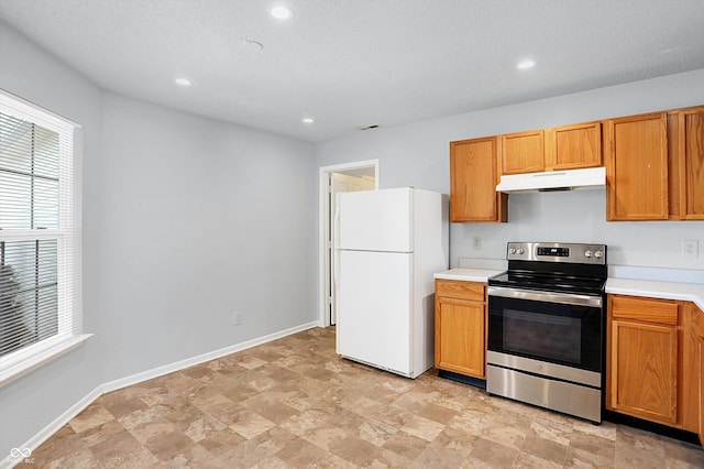 kitchen with stainless steel range with electric stovetop and white fridge