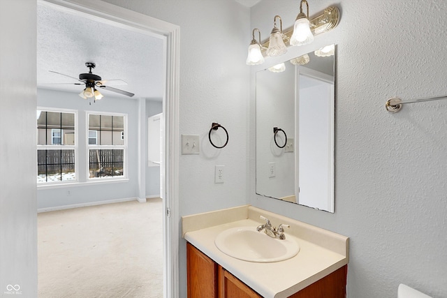 bathroom with a textured ceiling, ceiling fan, and vanity