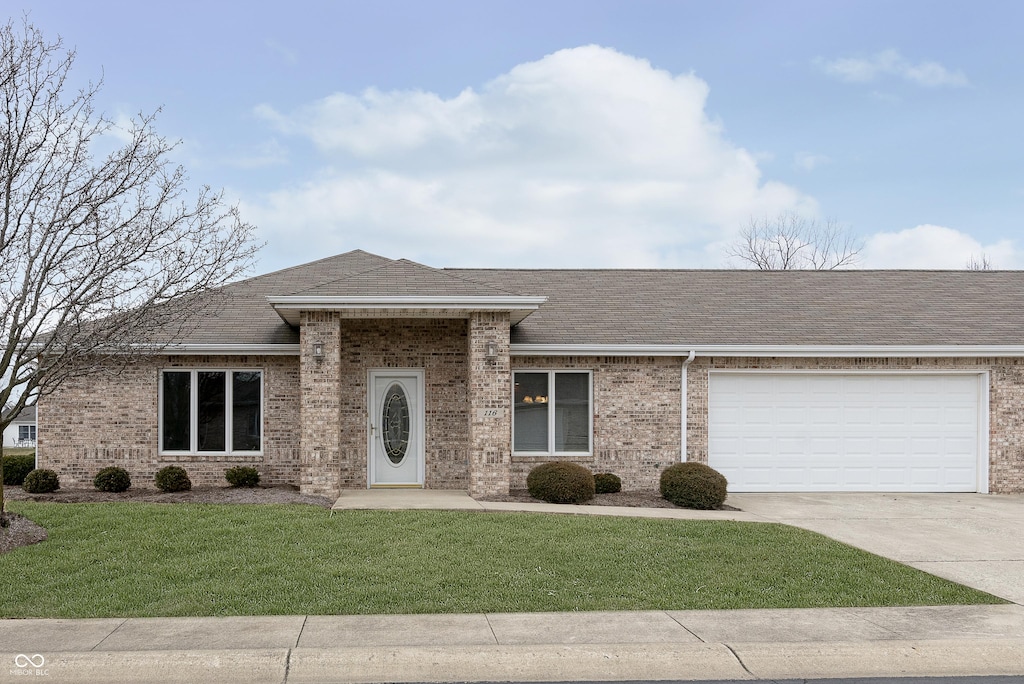 view of front of home featuring a garage and a front lawn