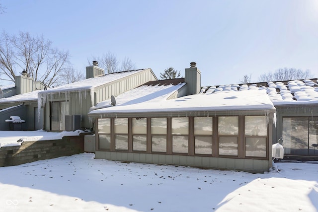 view of snow covered exterior featuring central AC